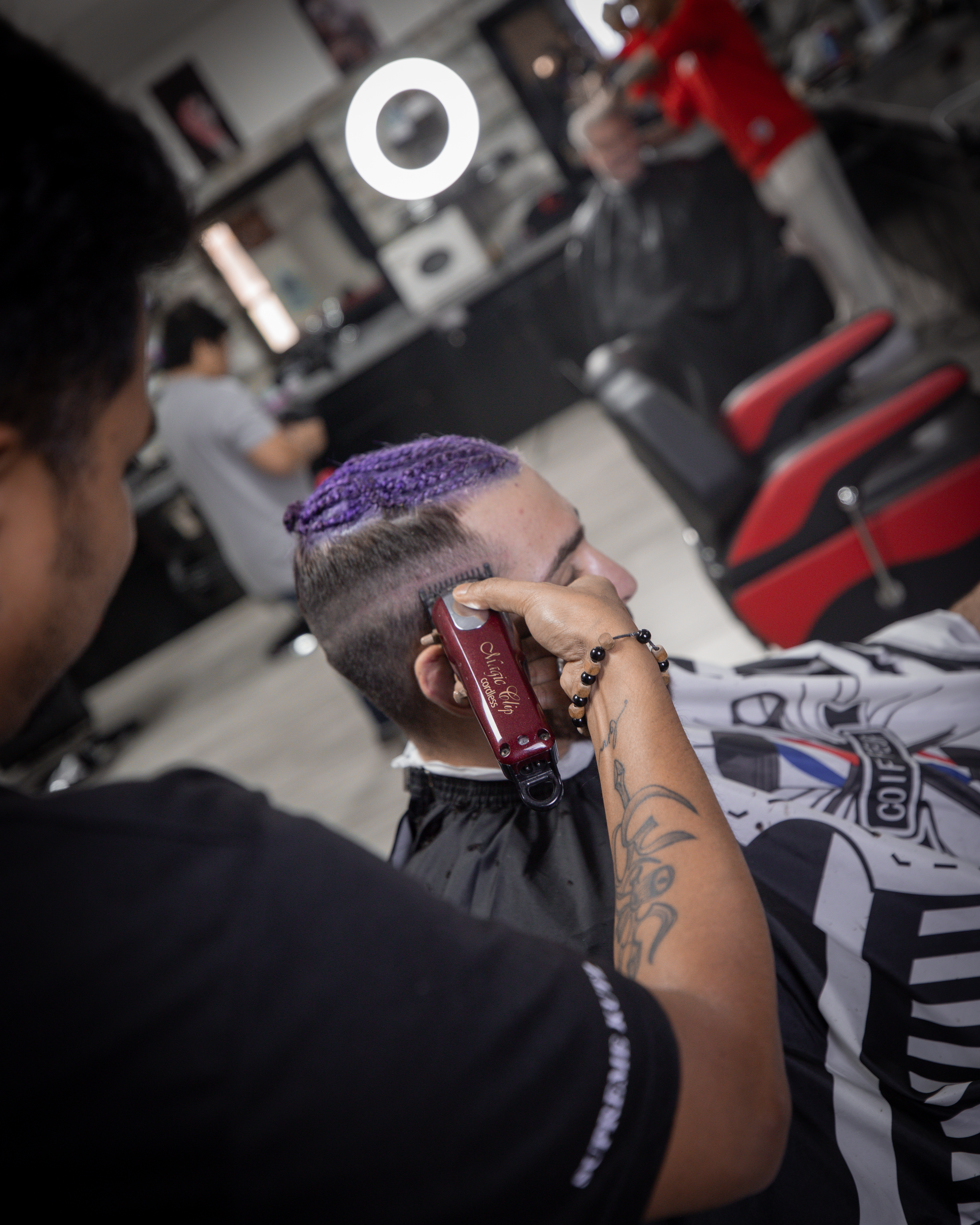 A barber giving a shave with a straight razor